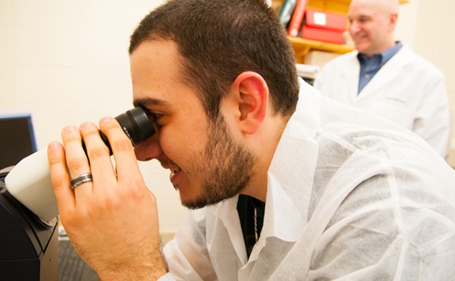 Student looking through a microscope