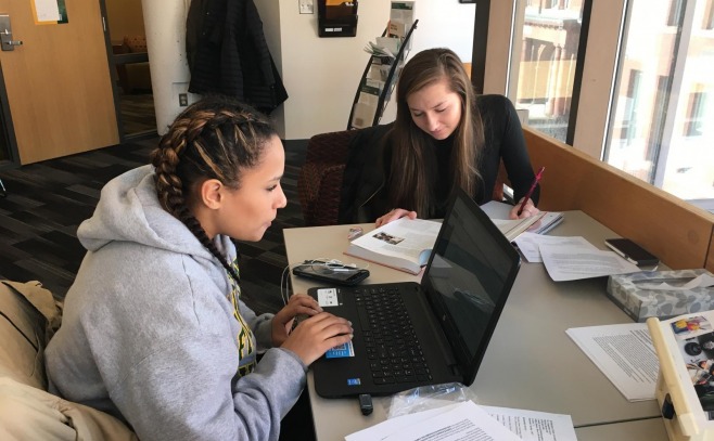 Two students studying in a dorm room