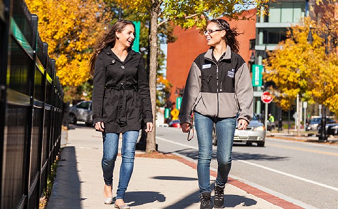 Students walking down sidewalk on campus