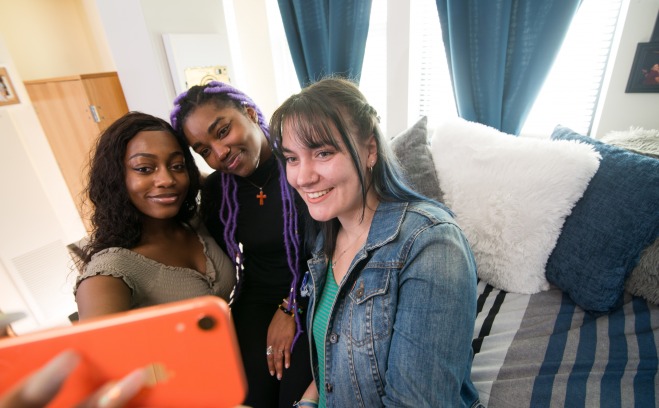 Fitchburg State students smiling as they take a selfie