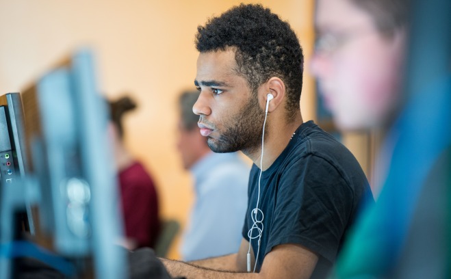 A student sitting at a computer 