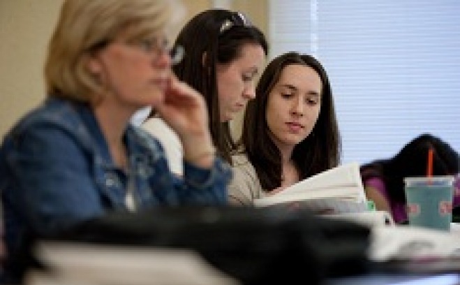 Students in class read from a text book