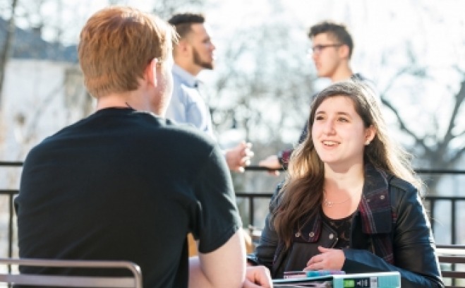 students sitting at a table outside of Hammond 