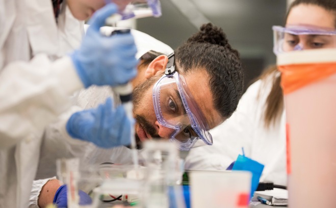 Students in lab with goggles and beakers