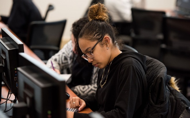 a student using a calculator in a mathematics classroom 