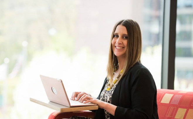 graduate female student with laptop in Hammond