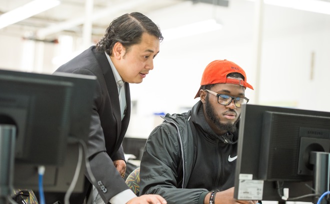 Engineering professor and student at computer in classroom
