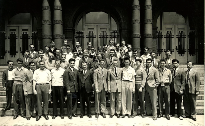 Male students standing in front of Palmer Hall on campus