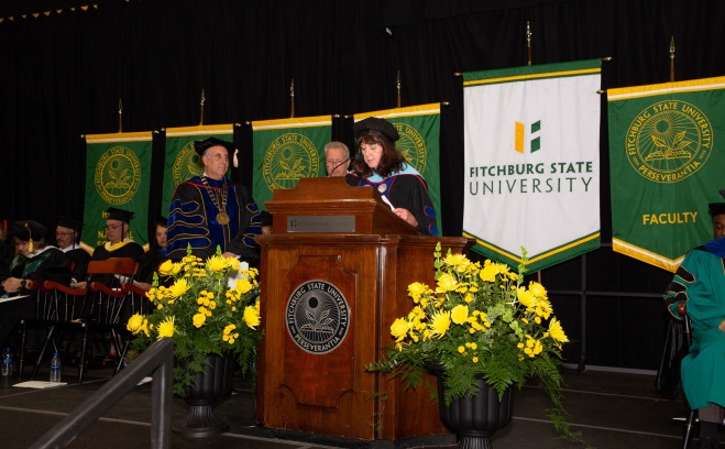 Cathy Canney giving speech at podium at commencement