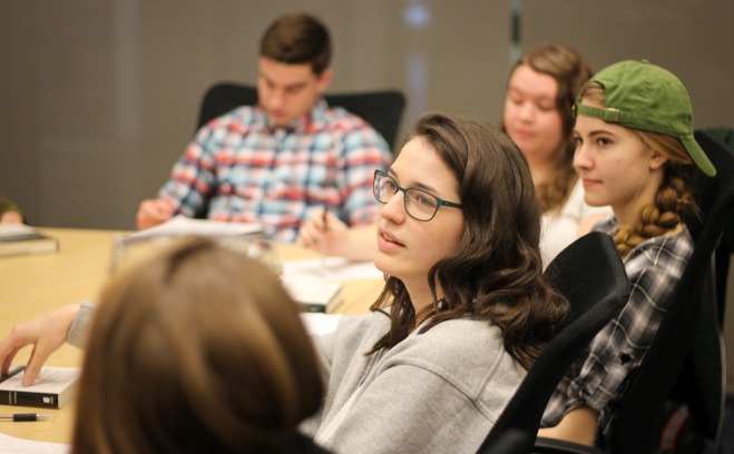 Students in English Honors Classroom discussing book