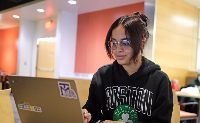 Female student in the hub on her laptop