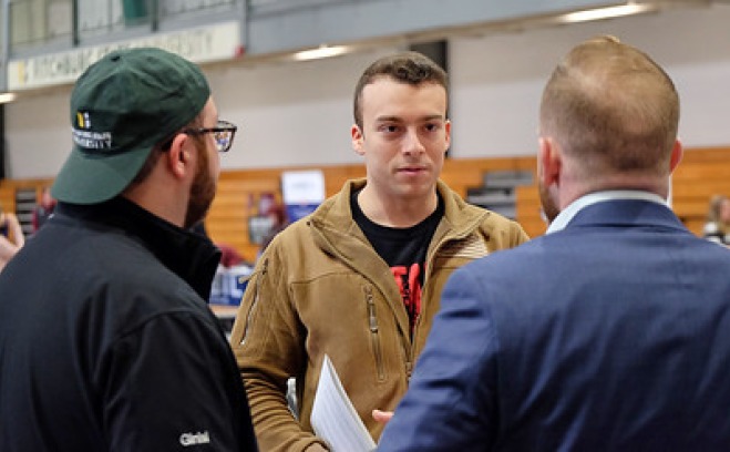 Male students at career fair in rec center