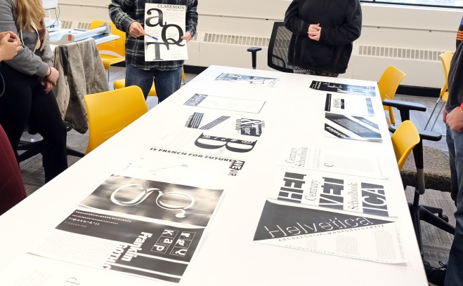 Professor Donald Tarallo reviews his student's work in their Typography Class