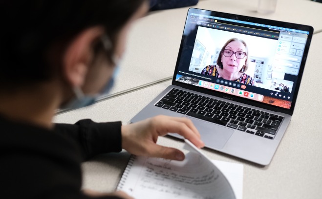 ALFA student mentor on laptop screen with undergraduate writing student