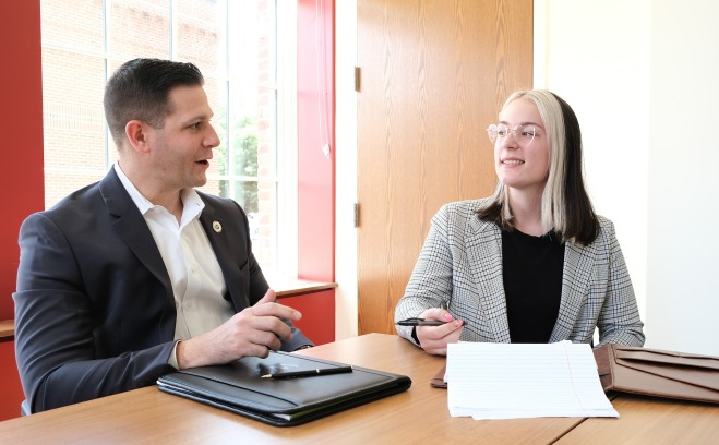 Rebecca Hess '22 and Michael Kushmerek State Rep at table in conference room