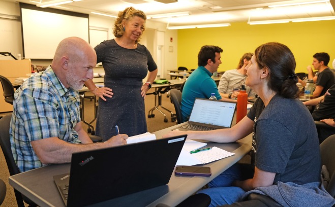 Teacher talking to adult students in AP classroom