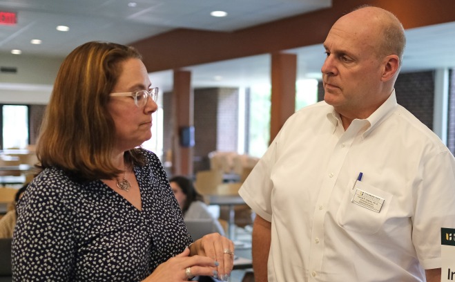 Sara Levine and David Weiss talking at orientation