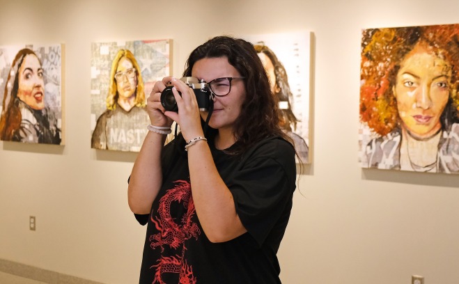 Girl taking photo in the art gallery