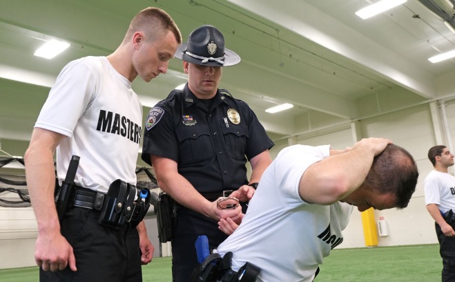 Police Academy students and officer working on handcuffing