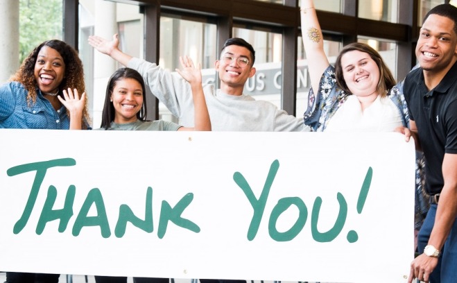 Happy Students from the Phoneathon Alumni Drive Holding Thank You Sign 