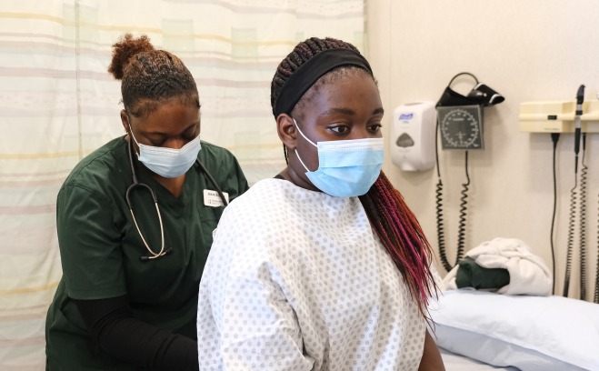 Nursing students one nurse on patient in respiratory lab