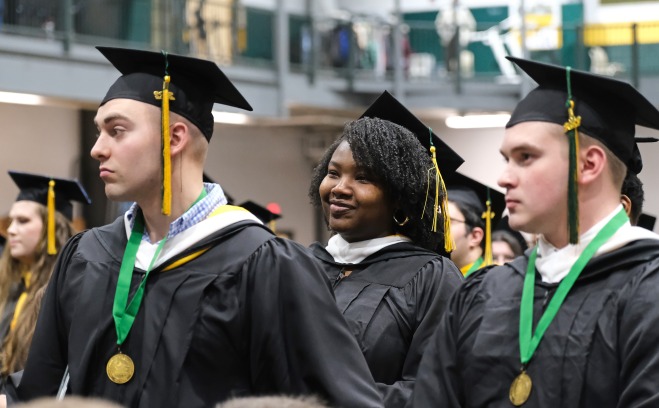 Students at end of winter commencement two male and two females