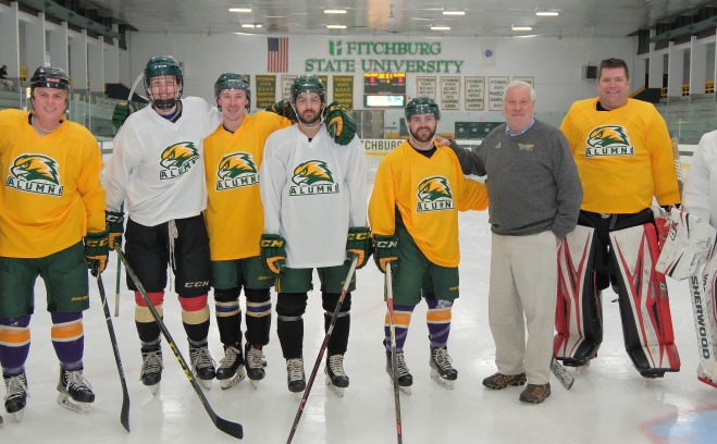 Alumni Hockey Players at Civic Center on Ice with coach