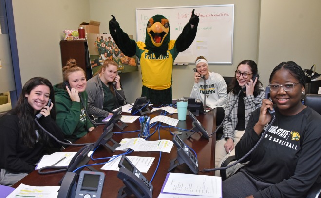 Freddy and female volunteers calling donors for Go Falcon Challenge