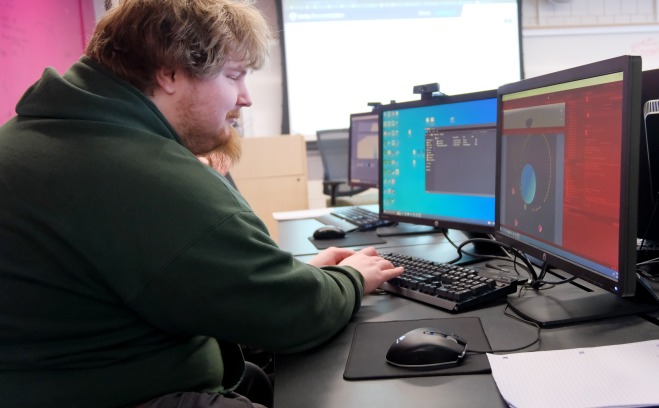 Male student working at computer