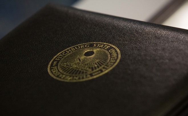 Black folder with university seal