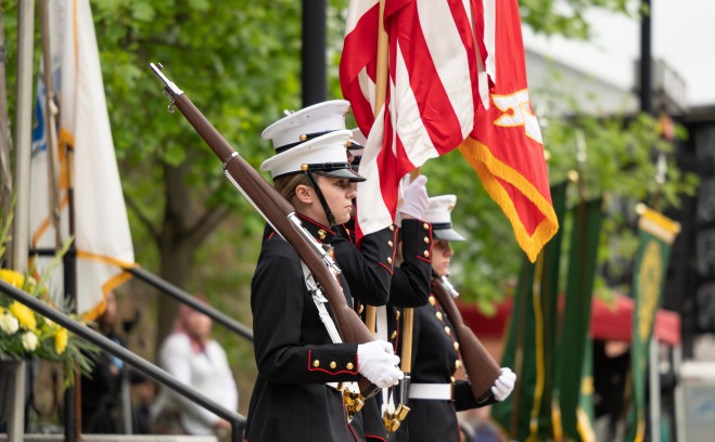 Color guard at undergrad commencement holding flags in front of Edgerly 