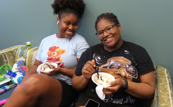 Two female students eating ice cream in CDI office