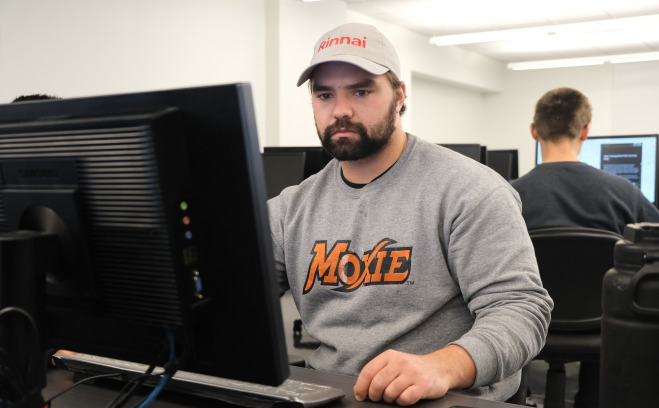 Male students in classroom at computers