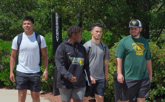 Football players walking on quad