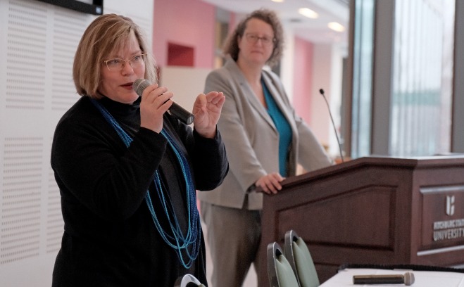 Laura Bayless talking at orientation with Pat Marshall looking on