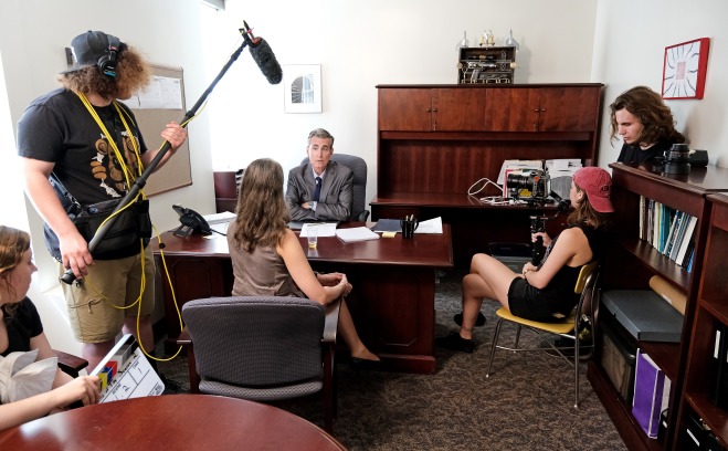 Students and actors filming in office