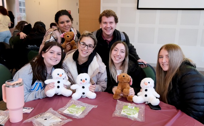 Students posing at table in main lounge