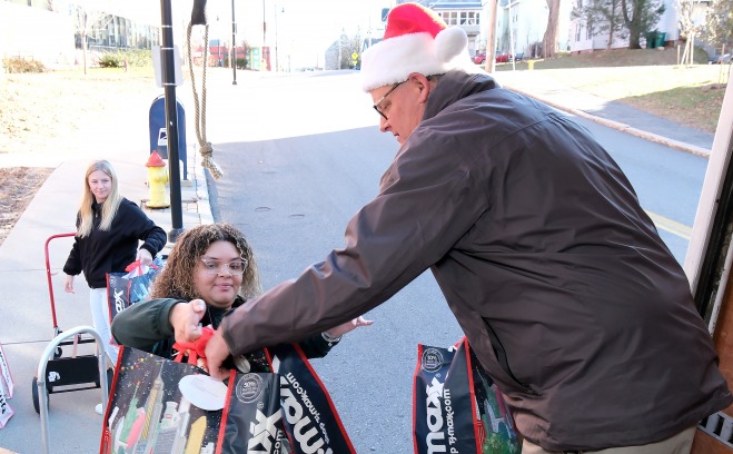 Students help load gifts in the truck for care and share