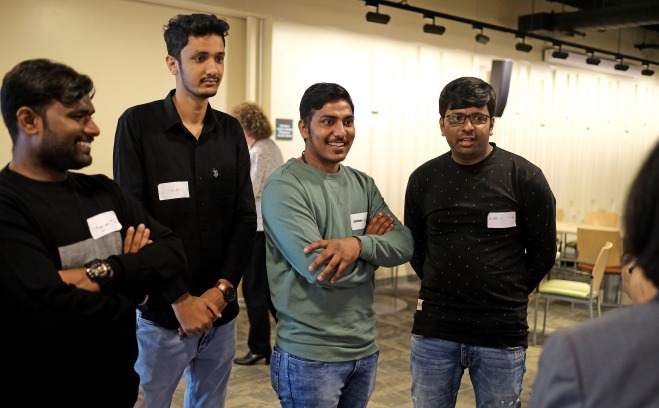 Male international students standing together in Falcon Hub