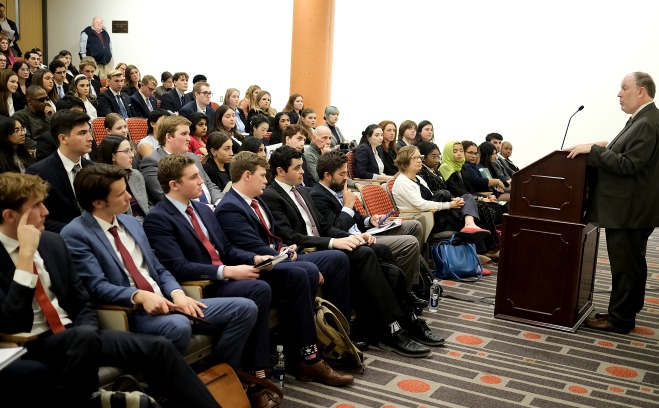 Paul Weizer at podium addressing moot court participants