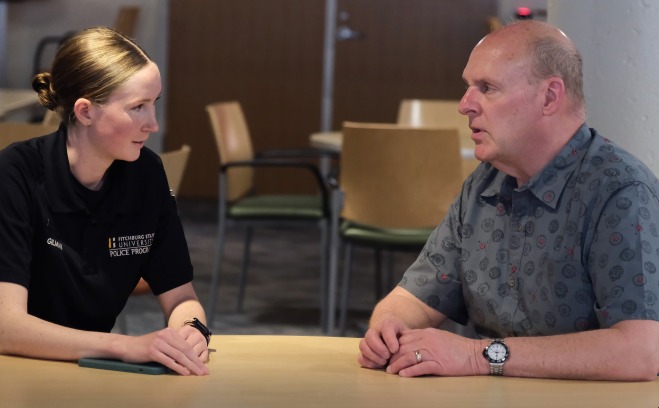 David Weiss advising a CJ graduate student at table in hub