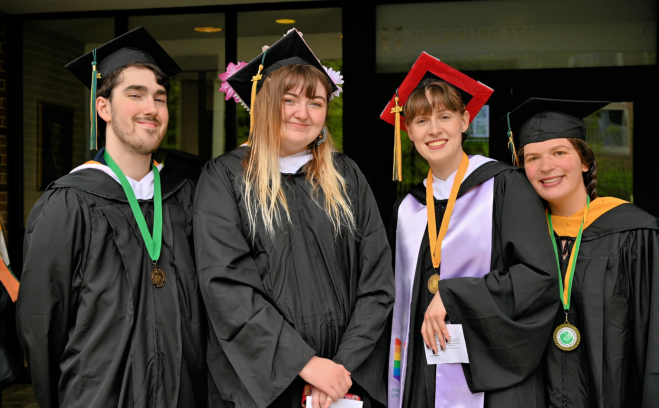 Photo of students smiling before start of commencement ceremony May 2024