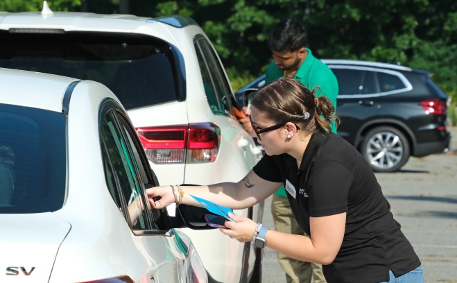 Housing staff checking cars in for move in