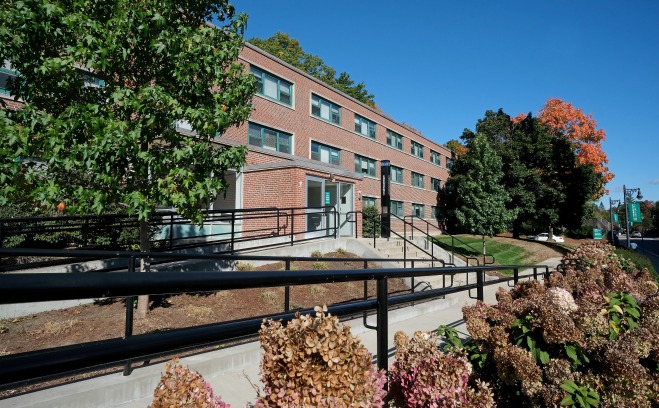 Exterior of Herlihy Hall with ramp trees and bushes