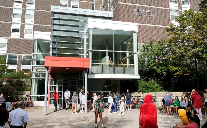 Student congregating outside Russell Towers during a fire drill