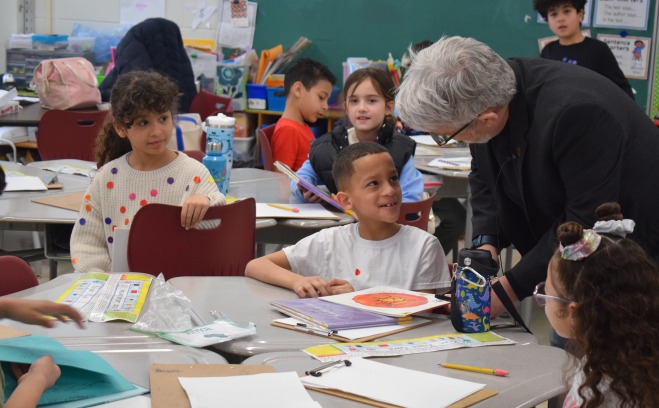 Students and teacher talking in McKay classroom