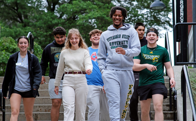 Smiling group of students walking down the stairs