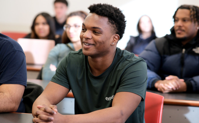 Students in the classroom at tables. 