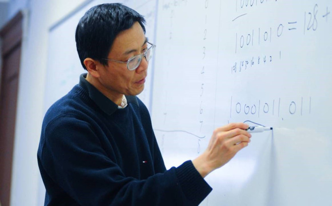 Brady Chen writing on whiteboard.