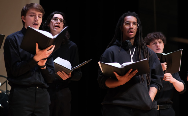 Male choir singers on stage at Music Mega Mix in Weston.